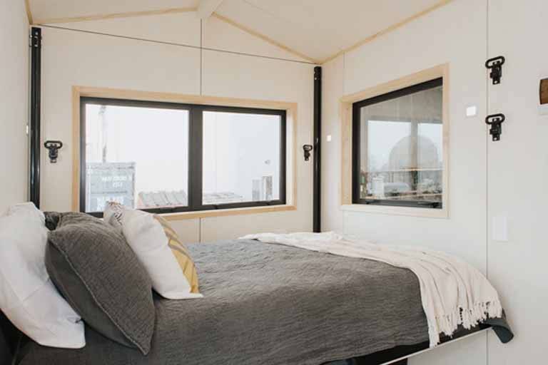 tiny house boosts living space with elevating bed