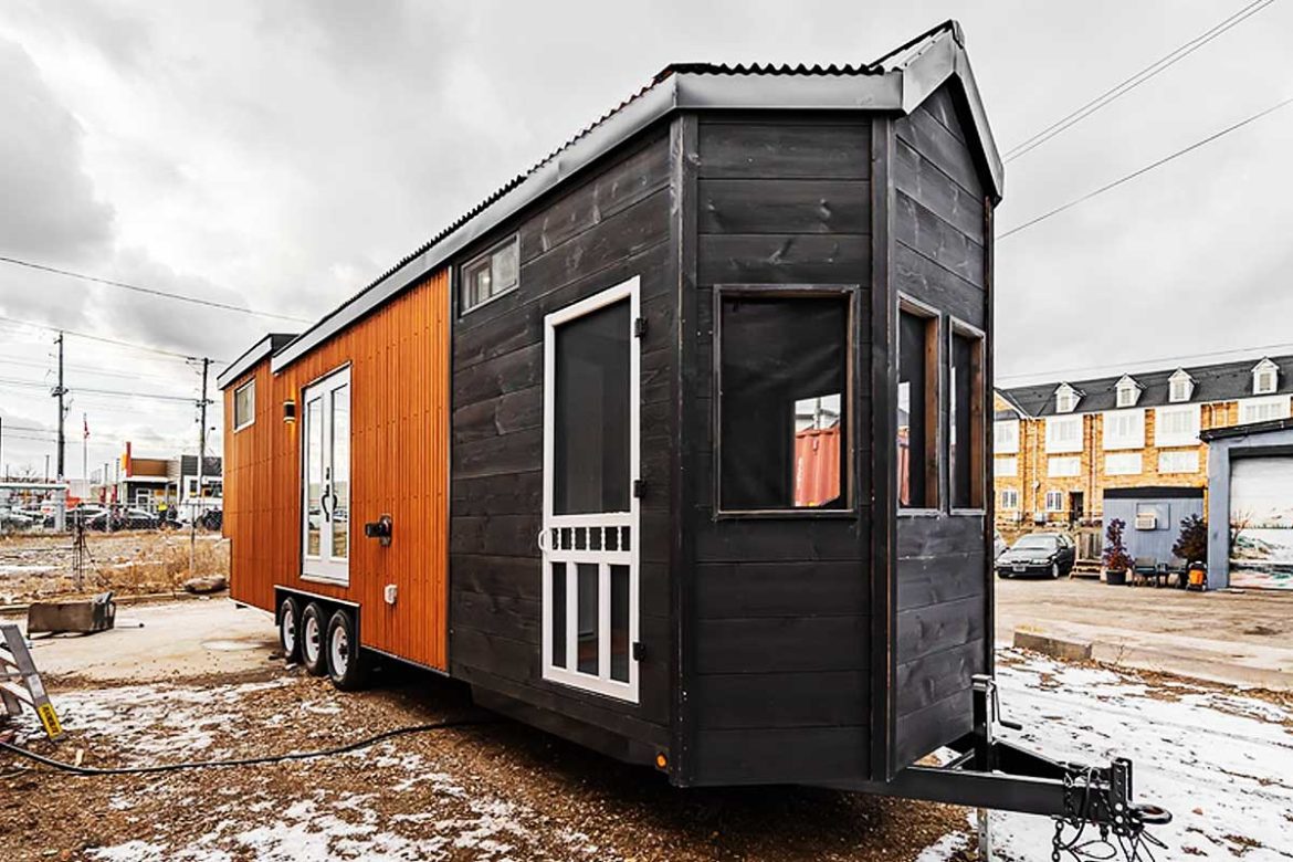 The 'Sherloak' tiny house for individuals with a porch behind the hidden bookshelf