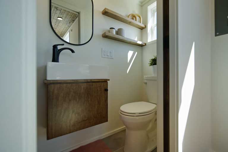 Stylish and functional bathroom with a gravity flush toilet and floating vanity.