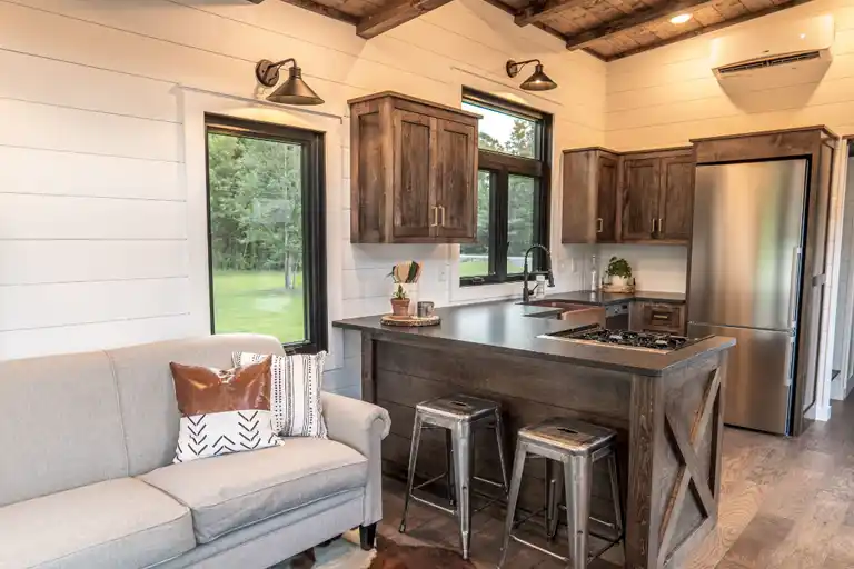 Spacious and functional kitchen with breakfast bar, copper sink, and modern appliances.