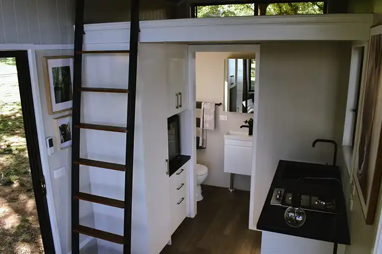 Full ensuite bathroom with a shower, flushing toilet, and vanity.