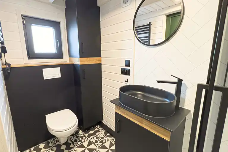 Elegant bathroom design with bottle green accents and a rain shower.