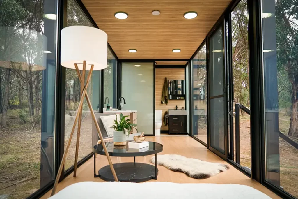 Modern bathroom with opaque glass door, flushing toilet, and shower.
