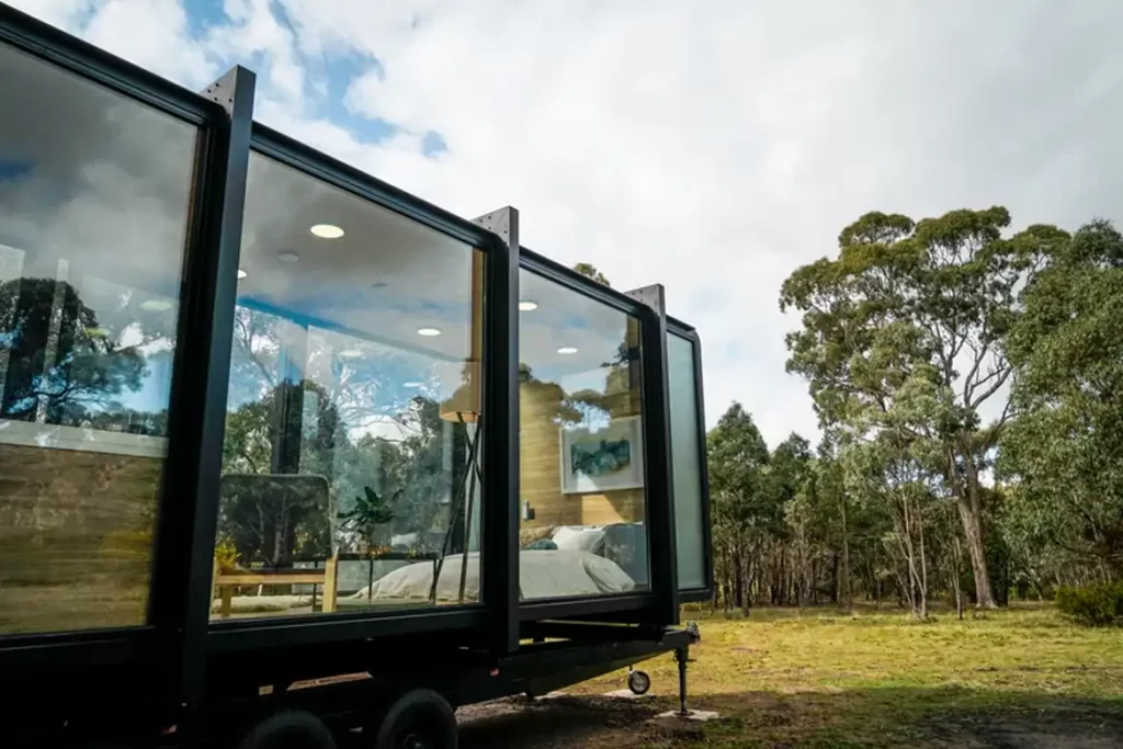 Exterior view of the Beaufort Bushland Retreat with floor-to-ceiling glass design.
