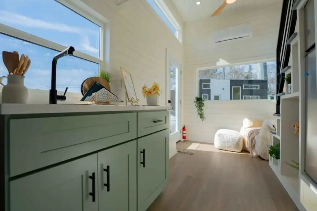 Main living area with wood shiplap walls and luxury vinyl flooring.